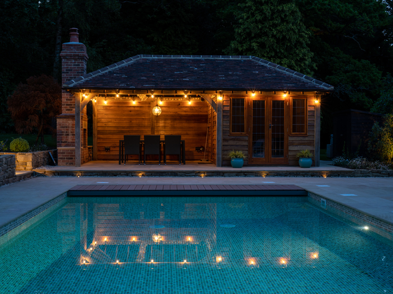Lit summerhouse and pool