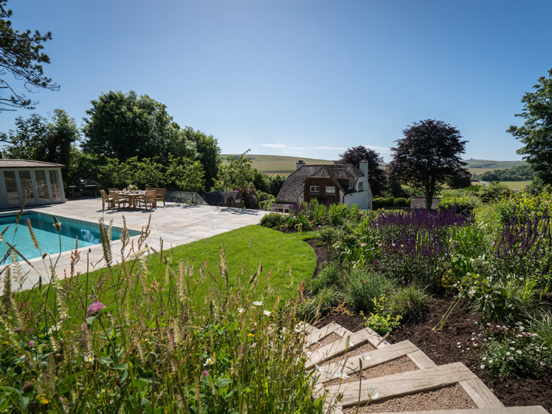 The steps leading down to the pool and pool house
