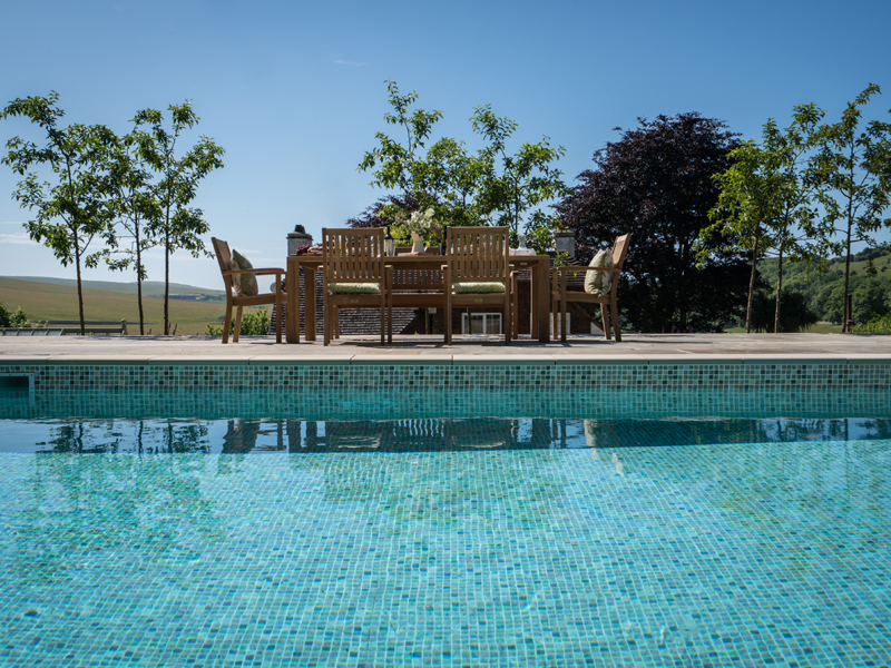 The pool has an automatic cover that disappears beneath the terrace